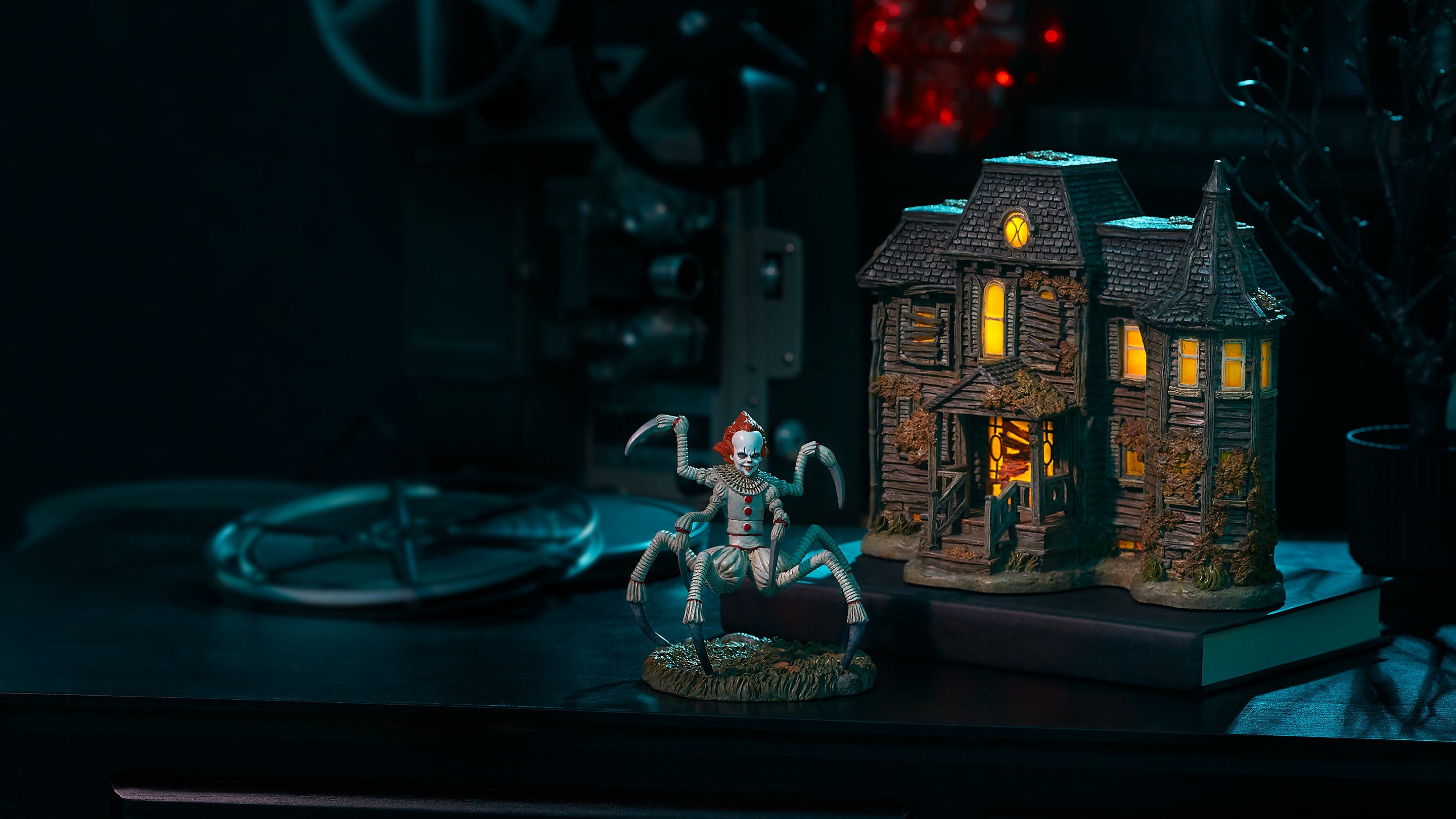 Small haunted house model with a skeleton figure on a dark background