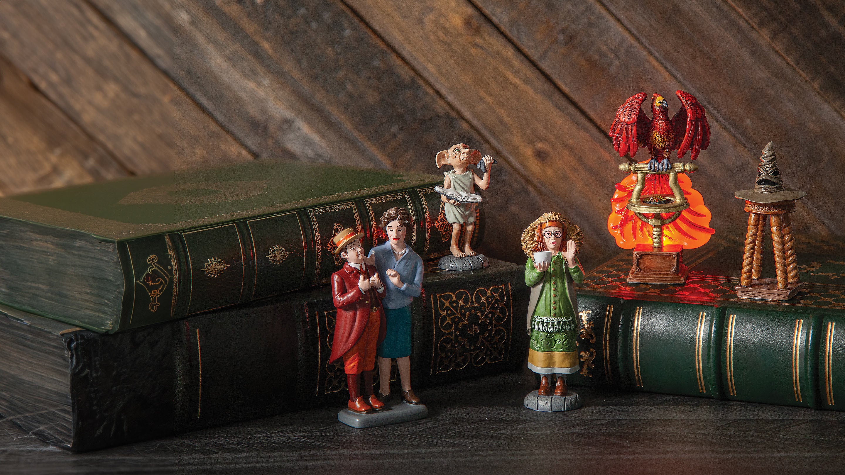 Figurines of children and animals on a large book with a wooden background