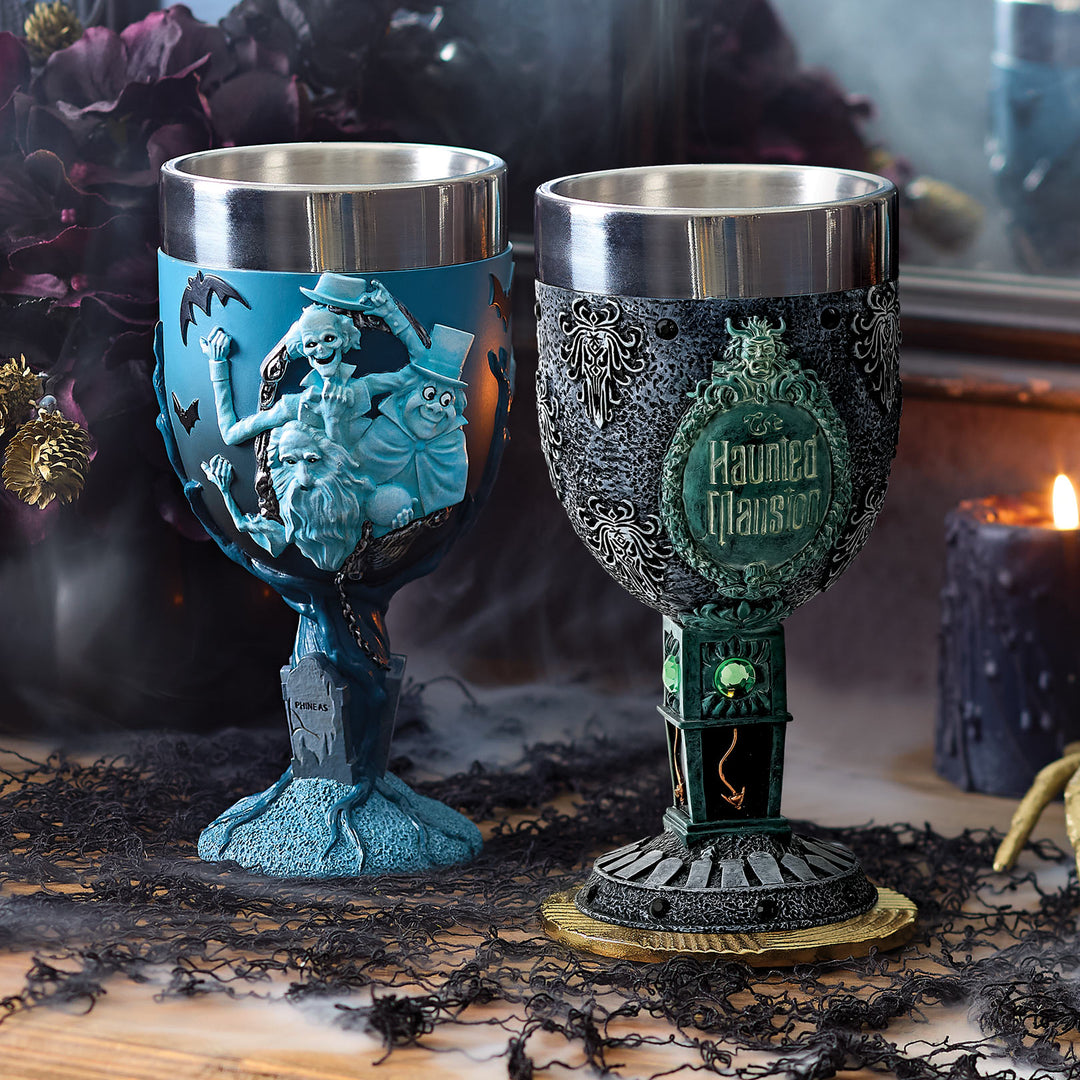 Two decorative goblets with intricate designs on a dark, Halloween-themed background.