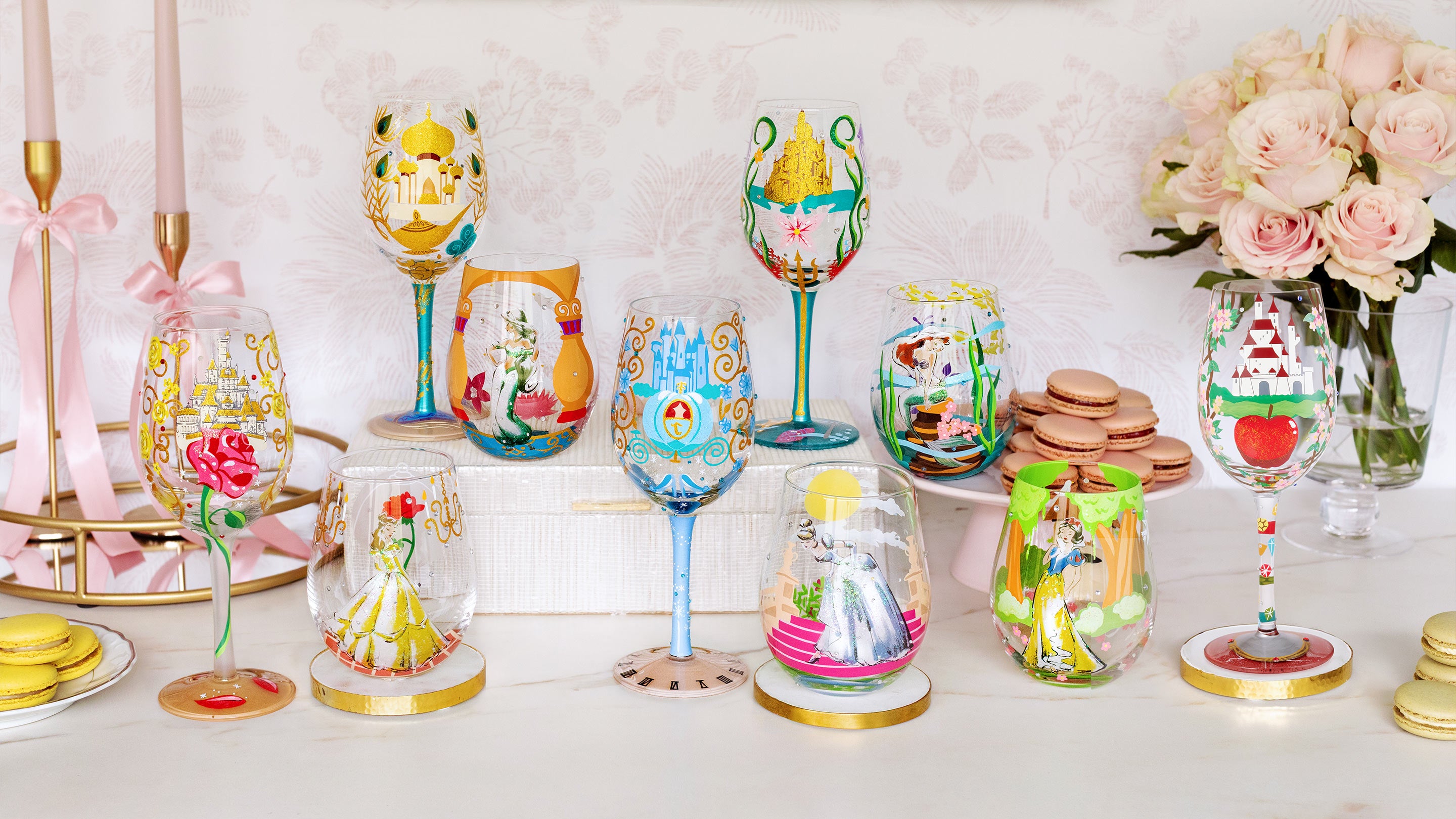 Colorful hand-painted glasses on a table with decorative elements.