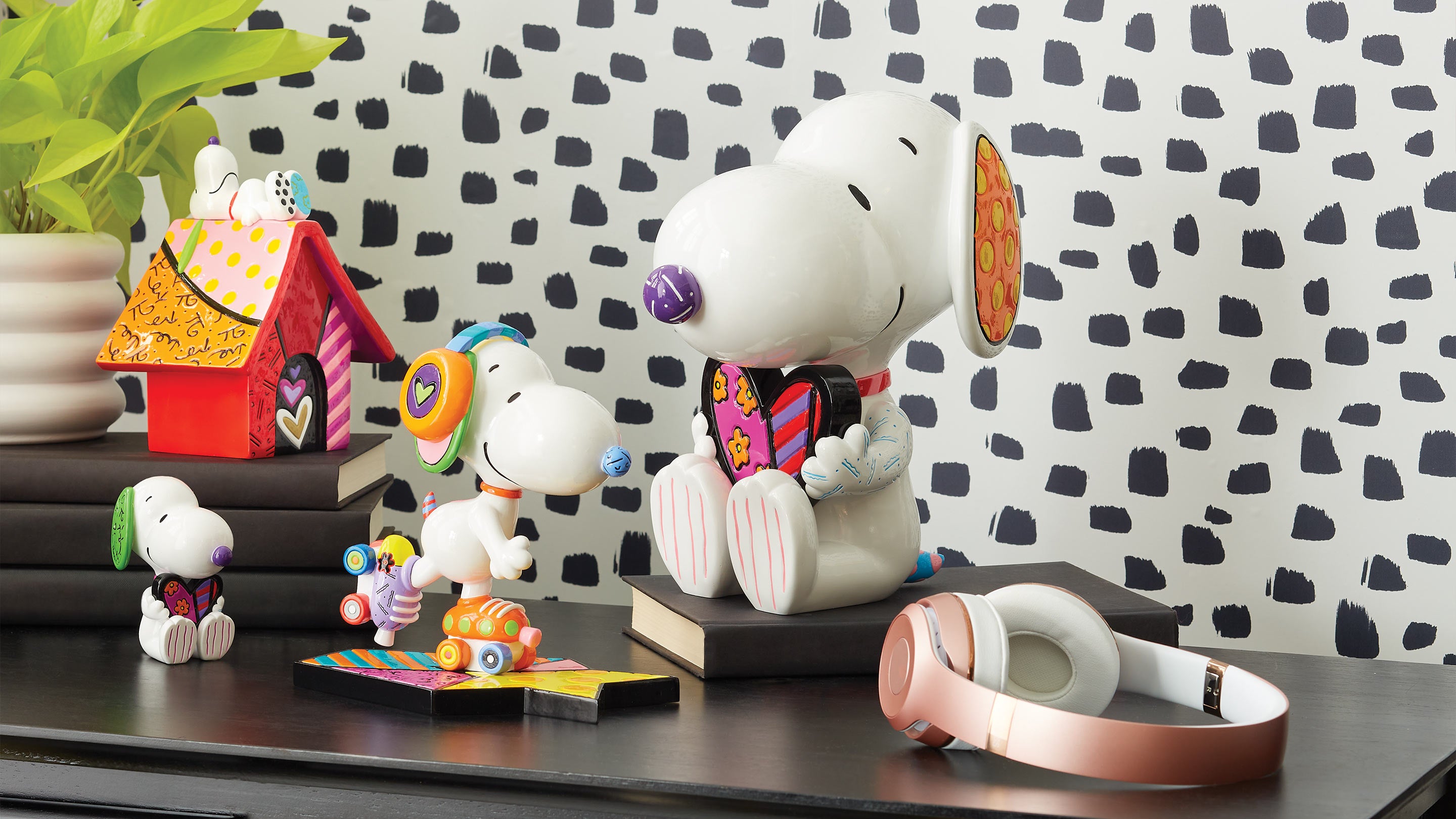 Snoopy figurines on a shelf with a polka dot wall in the background