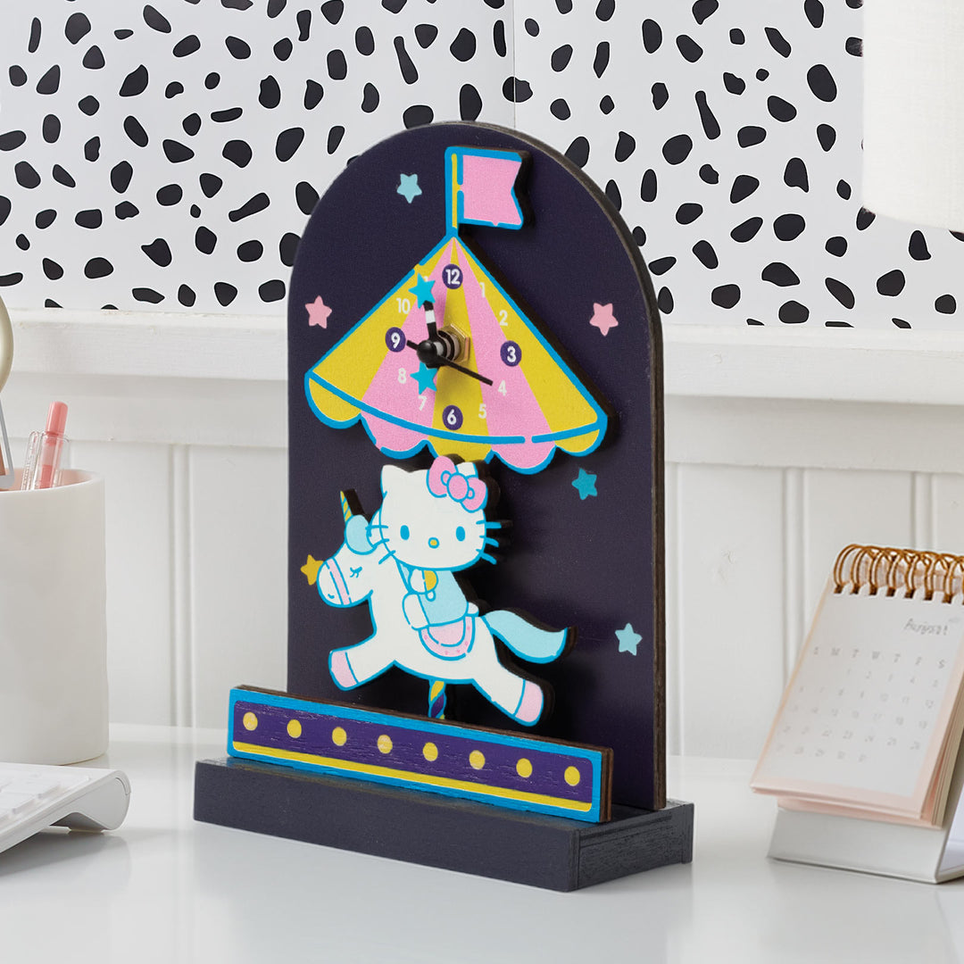 Desk clock with cartoon character design on a white surface with a patterned wall in the background